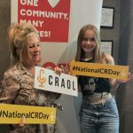 Two women stand in the 92.5 Phoenix FM studio promoting CRAOL's National Community Radio Day.